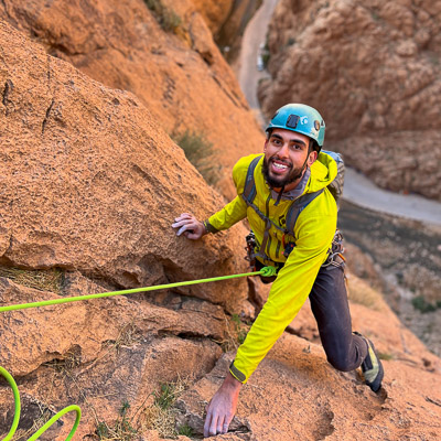 Person smiling while rock climbing in the Todra Gorge