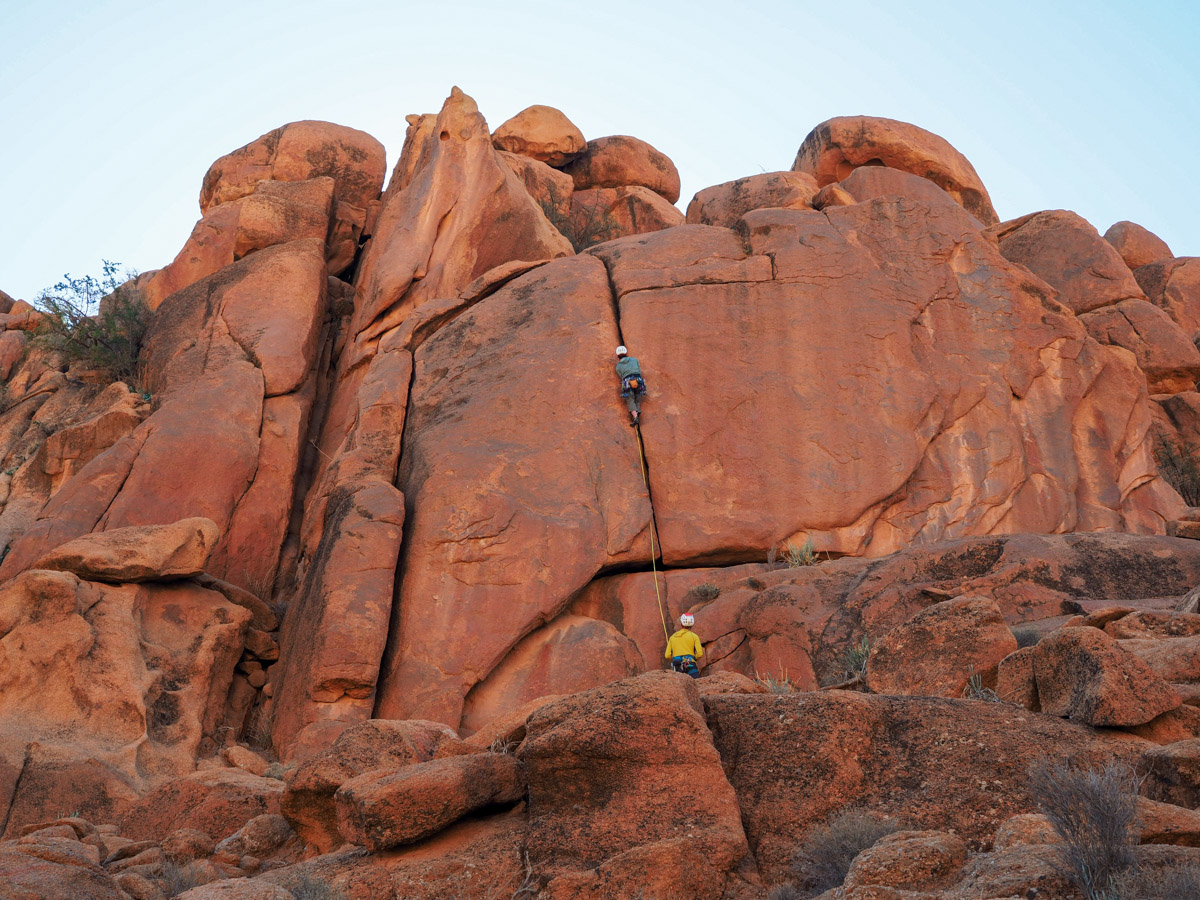 Person rock climbing on a crack climbing route called Fortress Crack in Tafraout